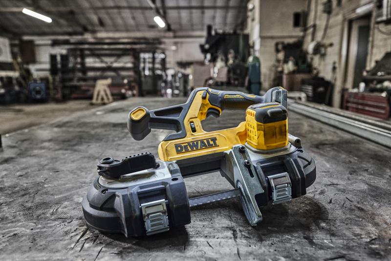 Scie à ruban sans fil DEWALT sur un établi en métal dans un atelier.